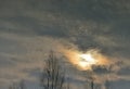 Reflection in the water of the sky with clouds, the setting sun and trees. Royalty Free Stock Photo