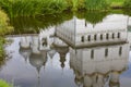 Reflection in the water of a white-stone Orthodox church