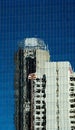 Reflection of a white building in the blue windows of a tall office building Royalty Free Stock Photo