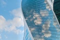 Reflection of white clouds and blue sky in glass wall of modern skyscraper Royalty Free Stock Photo