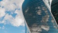 Reflection of white clouds in glass wall of modern skyscraper Royalty Free Stock Photo