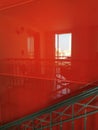 Reflection of a window on a red glossy wall.