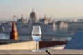 Reflection in wine glass of Hungary Paliament hazy figure in the background