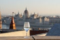 Reflection in wine glass of Hungary Paliament hazy figure in the background