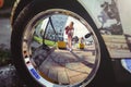 Reflection of a woman in a chrome car wheel Royalty Free Stock Photo