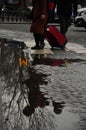 Reflection of a woman in a puddle. Metro, Paris, France Royalty Free Stock Photo