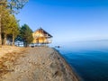 Reflection of a wooden house on the lake, house on the river Royalty Free Stock Photo