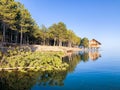 Reflection of a wooden house on the lake, house on the river Royalty Free Stock Photo