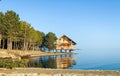 Reflection of a wooden house on the lake, house on the river Royalty Free Stock Photo