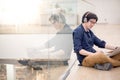 Young Asian business man listening to music while using laptop Royalty Free Stock Photo