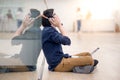 Young Asian business man listening to music while using laptop Royalty Free Stock Photo