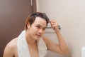 Reflection of Young Man Bushing Hair in Mirror Royalty Free Stock Photo