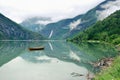 Reflections of Asafossen waterfall in Eide Lake