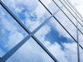 Reflections of blue sky and clouds in glass facade of modern off Royalty Free Stock Photo