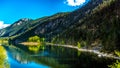 Reflections of blue sky, trees and mountains in the smooth surface on the crystal clear water of Crown Lake Royalty Free Stock Photo