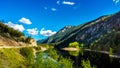 Reflections of blue sky, trees and mountains in the smooth surface on the crystal clear water of Crown Lake Royalty Free Stock Photo