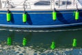 reflections of boat fenders on the side of a yacht