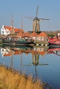 Reflections of boats and a windmill along Nieuwe Haven New Harbor close to Zuidhavenpoort in Zierikzee