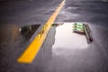 Reflections of buildings in puddles on the road. Royalty Free Stock Photo