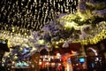 Reflections on a cafe's glass partition wall decorated with Christmas lights in 'Tirana Toptani Castle' Royalty Free Stock Photo