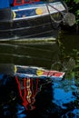 A canal boat moored and reflected in the River Stort. Royalty Free Stock Photo