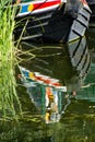A canal boat moored and reflecting in the River Stort Royalty Free Stock Photo