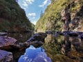 Reflections in a canyon at Karangahake gorge in afternoon in New Zealand Royalty Free Stock Photo