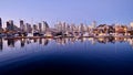 Reflections of city lights and boats in calm water. Royalty Free Stock Photo