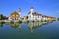 REFLECTIONS OF COLORFUL BUILDINGS ON THE WATER OF THE RIVER NAVIGLIO IN GAGGIANO VILLAGE IN ITALY