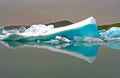 Reflections of crystal blue and white icerbergs in black dark water in dim gloomy light - Jokulsarlon Glacier Lagoon, Iceland Royalty Free Stock Photo