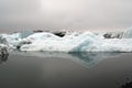 Reflections of crystal blue and white icerbergs in black dark water in dim gloomy light - JÃÂ¶kulsÃÂ¡rlÃÂ³n Jokulsarlon Glacier Royalty Free Stock Photo