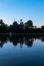 Reflections in deep blue water symmetry silhouette landscape nature alley park shore forest island