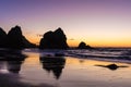 Reflections of giant rocks in the wet sand. Royalty Free Stock Photo