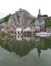 Reflections of gorgeous church and architecture on the Meuse river at Dinant, Belgium Royalty Free Stock Photo