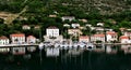 Reflections of the harbour and village in teh bay Royalty Free Stock Photo