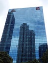 The reflections of high rise buildings in another glass paneled high-rise building