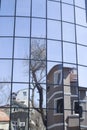 Reflections of houses and trees in a new glass building Royalty Free Stock Photo