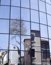 Reflections of houses and trees in a new glass building Royalty Free Stock Photo