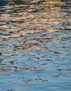 Reflections make the sea sparkle. Orange and red colors on transparent water surface background Royalty Free Stock Photo