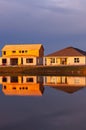 Reflections of new houses, being built on shoreline ofa lake Royalty Free Stock Photo