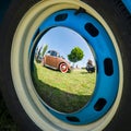 Reflections of an old car in the decorative wheel covers Royalty Free Stock Photo