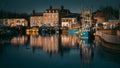 Reflections of the quayside soon after sunrise. Royalty Free Stock Photo