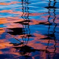 Reflections of sailboat masts create zigzag patterns on the surface of the water. Royalty Free Stock Photo