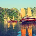 Reflections of sailing junks on Ha Long Bay Vietnam Royalty Free Stock Photo