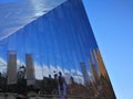 Reflections on side of modern glass structure against blue sky Royalty Free Stock Photo