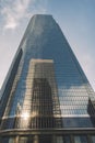 Tall Glass Sky Scraper Leading up to Blue Sky and Clouds Royalty Free Stock Photo