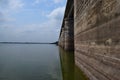 Reflections of Strength - A Strong Wall of Dam Reflected in Water with Open Sky