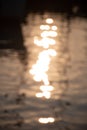 Reflections of sun and masts of a sailing vessel on the waterr Royalty Free Stock Photo