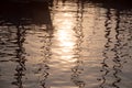 Reflections of sun and masts of a sailing vessel on the waterr Royalty Free Stock Photo