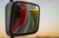 Reflections of the sunset in the rearview mirror of the truck